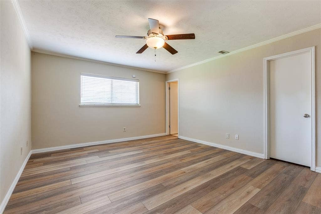 929 Arbor Downs Drive, Plano, TX 75023 Interior space featuring wood-finish flooring, neutral wall paint, and a ceiling-mounted light fixture with a fan