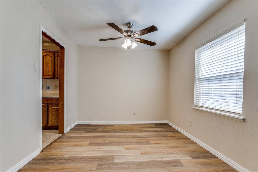 929 Arbor Downs Drive, Plano, TX 75023 Room featuring wood-finish flooring, a ceiling fan with integrated lighting, and a window with horizontal blinds