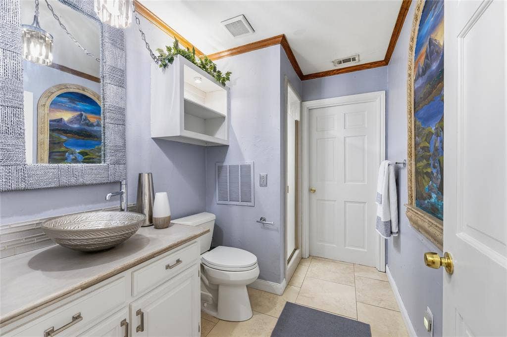 1509 Aylesbury Lane, Plano, TX 75075 Bathroom offers designer bowl sink, concrete countertop, separate walk-in shower. This bathroom is multipurpose, great for downstairs guest and has pool access!