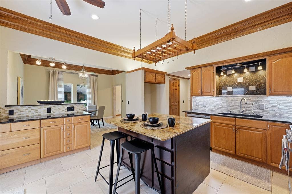 1509 Aylesbury Lane, Plano, TX 75075 This kitchen offers stainless steel appliances, double oven, granite countertops, pantry and smal storage room.