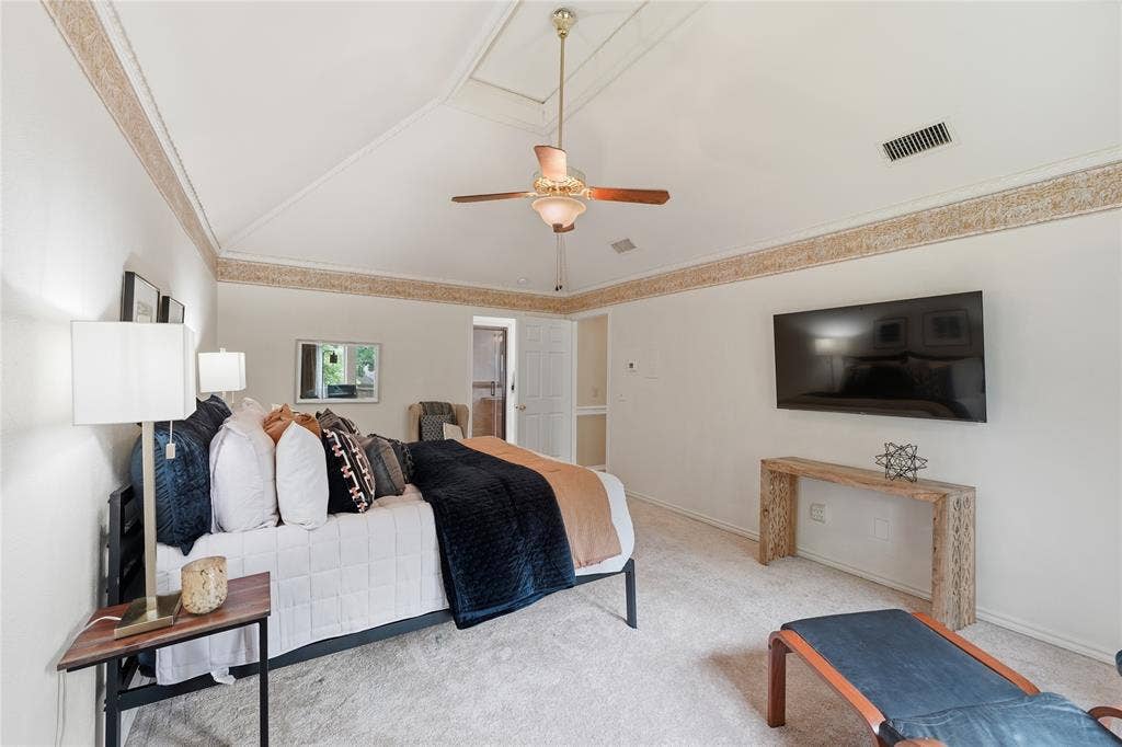 1509 Aylesbury Lane, Plano, TX 75075 Oversized Primary bedroom offers vaulted ceilings, a sitting area and a great view outside the picturesque street lined with trees.