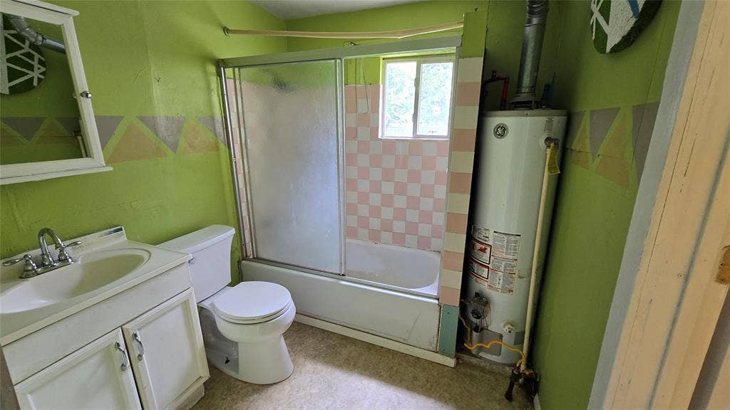 922 Hollywood Avenue, Dallas, TX 75208 Bathroom featuring a white vanity cabinet, ceramic sink with a chrome faucet, bathtub-shower combination with sliding glass doors, and a tiled shower surround