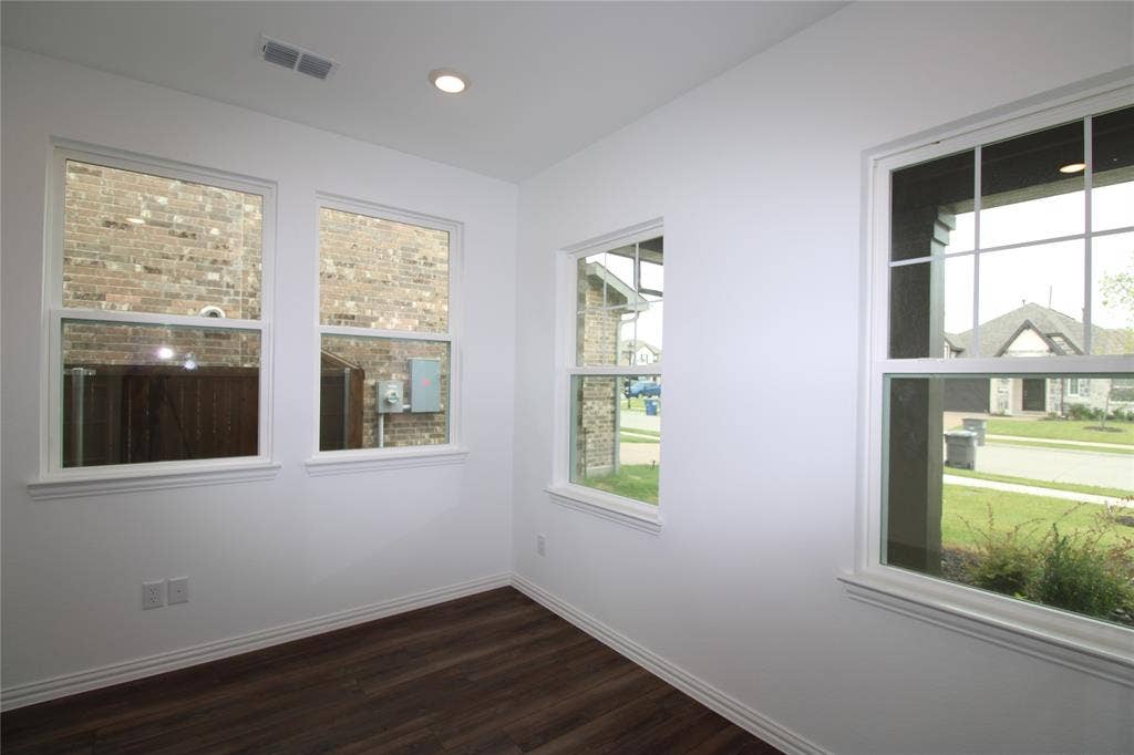 2603 Swallowtail Street, Melissa, TX 75454 Bright interior featuring multiple windows with grid muntins, wood-finish flooring, and recessed lighting