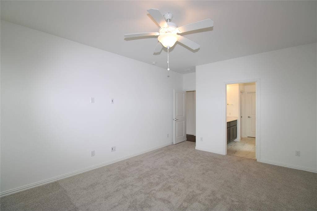 2603 Swallowtail Street, Melissa, TX 75454 Neutral-toned carpeted flooring, white interior walls, and a ceiling-mounted fan with integrated lighting