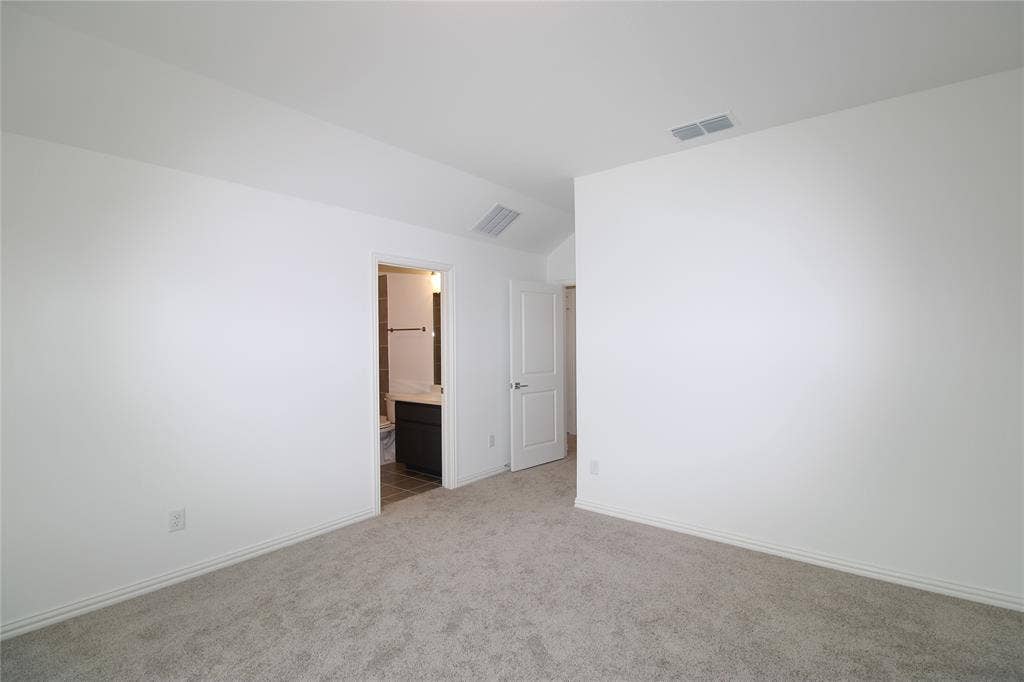 2603 Swallowtail Street, Melissa, TX 75454 Neutral-toned carpeting, vaulted ceiling, and white interior doors