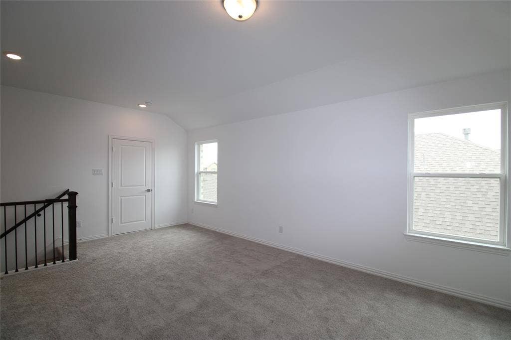 2603 Swallowtail Street, Melissa, TX 75454 Neutral interior space featuring wall-to-wall carpeting, recessed lighting, dual windows, and a staircase with metal balusters
