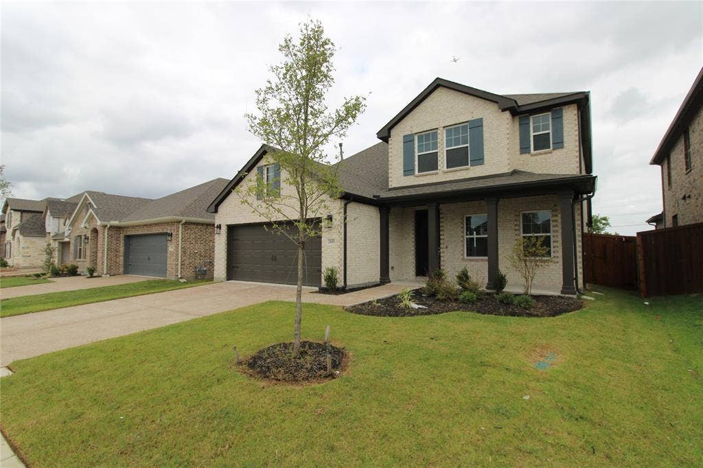 2603 Swallowtail Street, Melissa, TX 75454 Two-story brick exterior featuring a covered front porch, dark-toned shutters, and a multi-car garage with a concrete driveway
