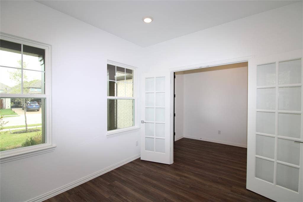 2603 Swallowtail Street, Melissa, TX 75454 Interior space featuring wood-finish flooring, recessed lighting, double French doors with glass panes, and windows with grids