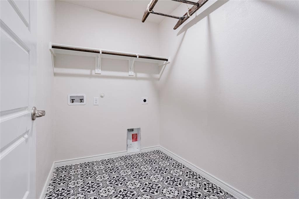 610 Overlook Point, Lavon, TX 75166 Laundry room featuring patterned tile flooring, built-in shelving, and utility hookups