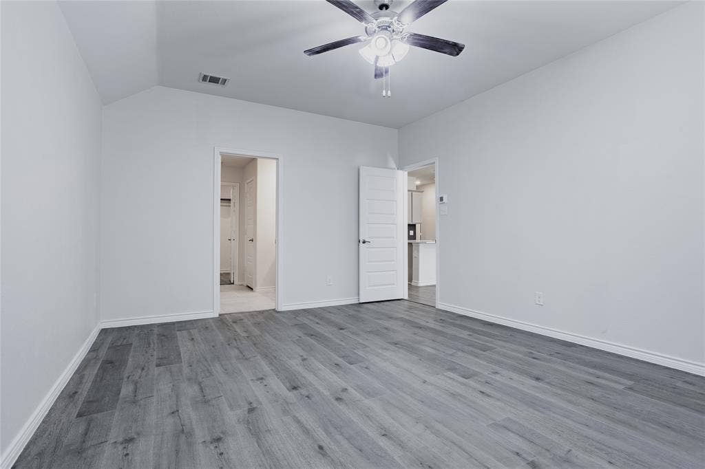 610 Overlook Point, Lavon, TX 75166 Room with vaulted ceilings, wood-finish flooring, and a central ceiling fan with integrated lighting