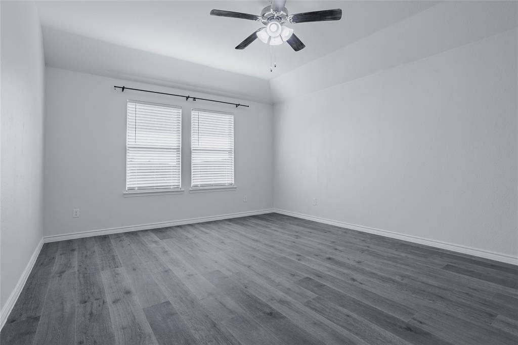 610 Overlook Point, Lavon, TX 75166 Tray ceiling featuring a central brushed-nickel finish ceiling fan with light kit, paired with wood-finish flooring and dual windows with window blinds