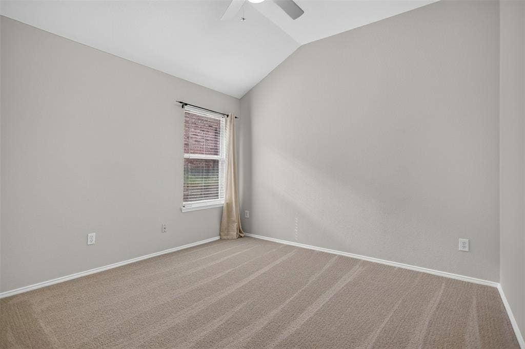 2691 Eganridge Lane, Rockwall, TX 75087 Vaulted ceiling with neutral wall tones, wall-to-wall carpeting, and a single-pane window