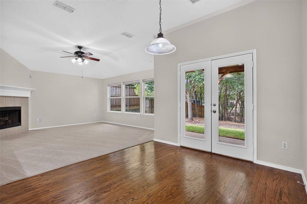 2691 Eganridge Lane, Rockwall, TX 75087 Vaulted ceilings, wood-finish flooring, fireplace with a mantel, ceiling fan, and double-glass paneled doors