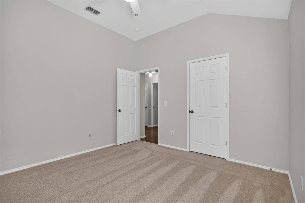 2691 Eganridge Lane, Rockwall, TX 75087 Vaulted ceilings, neutral wall palette, carpeting, and interior six-panel doors