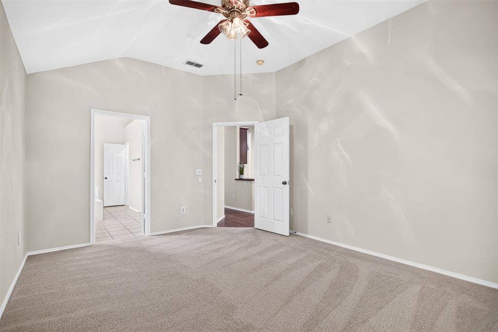 2691 Eganridge Lane, Rockwall, TX 75087 Vaulted ceilings featuring a multi-blade lighted ceiling fan and neutral wall finishes