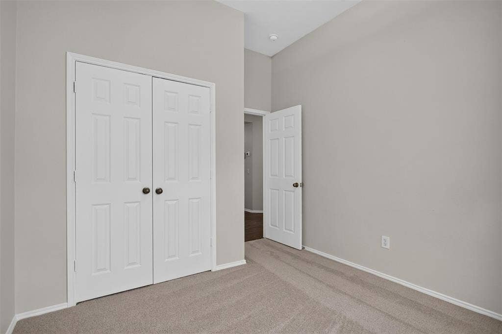 2691 Eganridge Lane, Rockwall, TX 75087 Interior space featuring neutral wall tones, high ceilings, carpeting, and six-panel doors