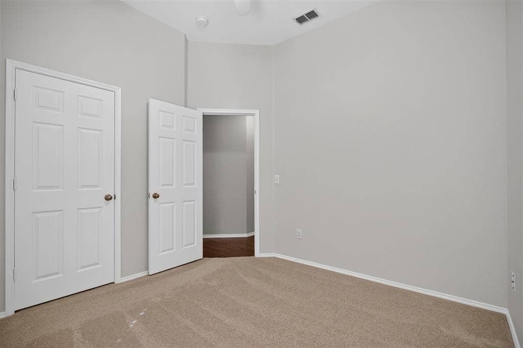 2691 Eganridge Lane, Rockwall, TX 75087 Neutral-toned room featuring plush carpeting, vaulted ceilings, and white six-panel interior doors
