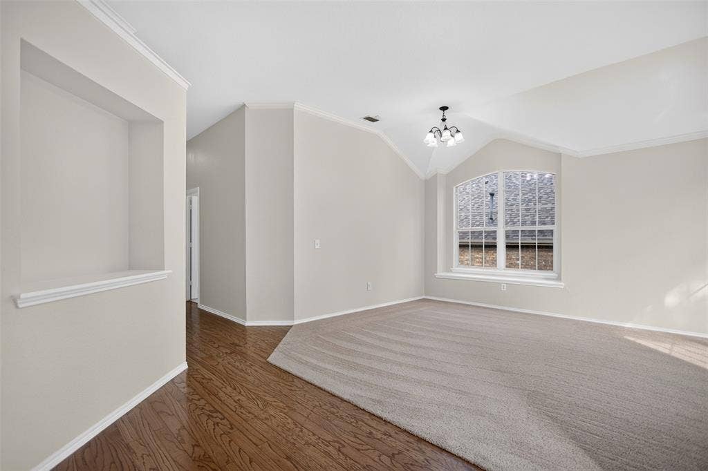 2691 Eganridge Lane, Rockwall, TX 75087 Vaulted ceilings, arched window with a deep sill, built-in wall niche, wood-finish flooring, and crown molding