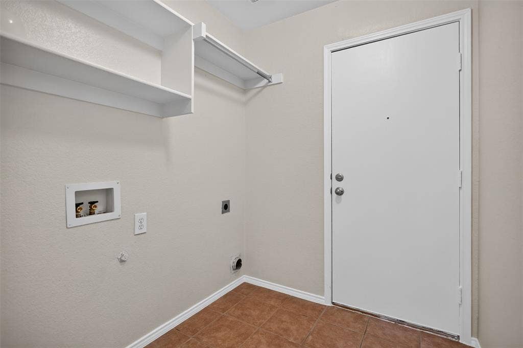 2691 Eganridge Lane, Rockwall, TX 75087 Utility space featuring ceramic tile flooring, built-in white shelving, and dedicated plumbing connections