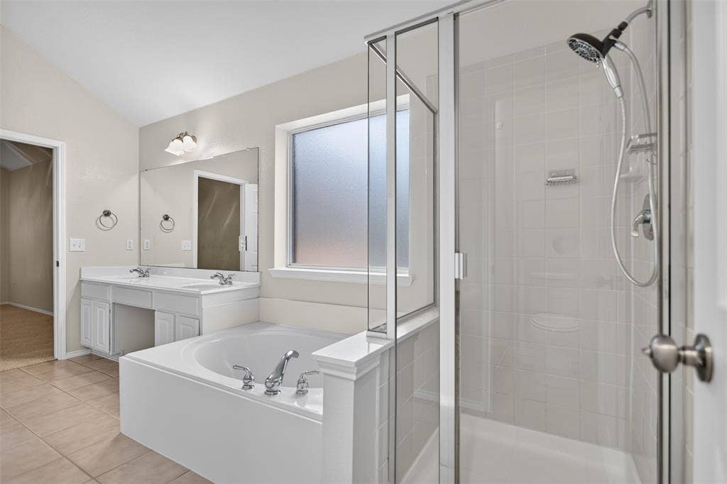 2691 Eganridge Lane, Rockwall, TX 75087 Bathroom featuring a glass-enclosed shower, soaking tub, dual-sink vanity with countertop, and tile flooring