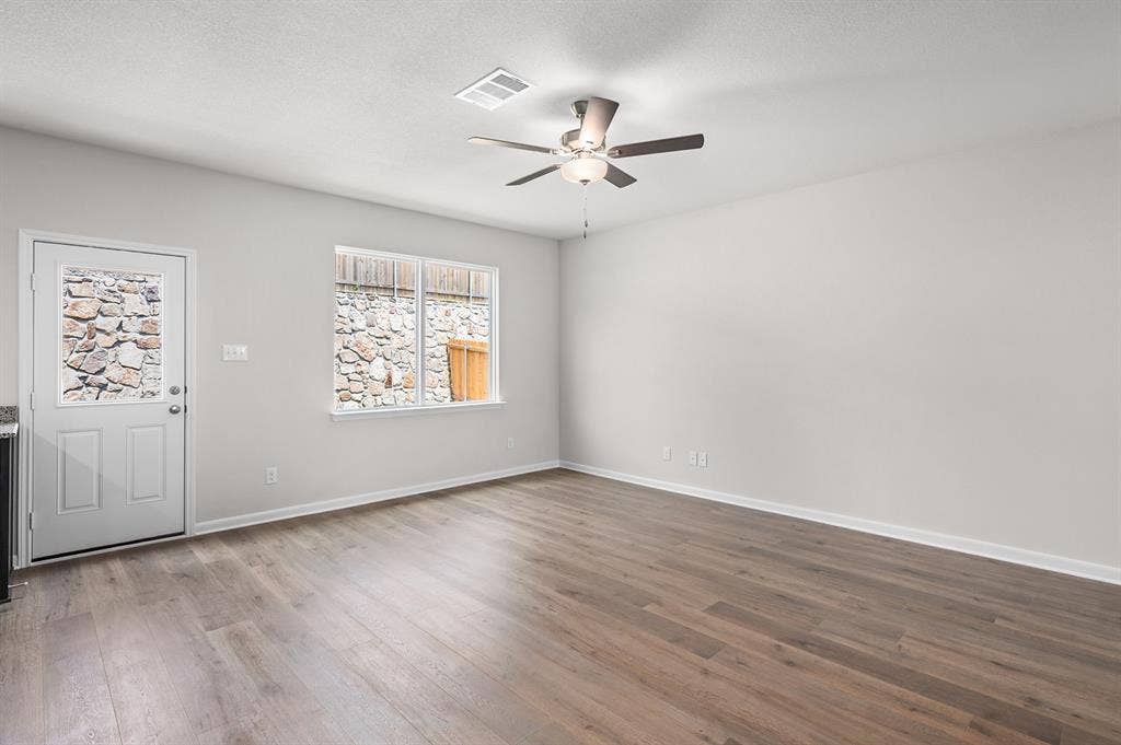 6307 Crosswood Lane, Dallas, TX 75241 Foyer entrance with light wood-style flooring, ceiling fan, and a textured ceiling