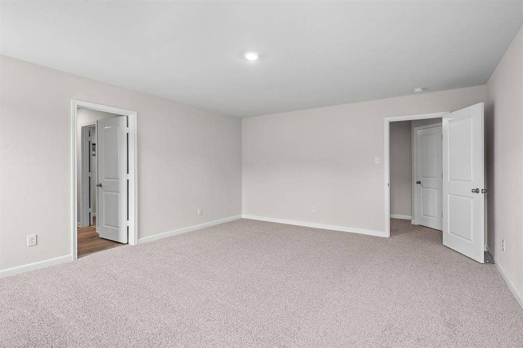 6307 Crosswood Lane, Dallas, TX 75241 Unfurnished bedroom featuring light carpet and baseboards
