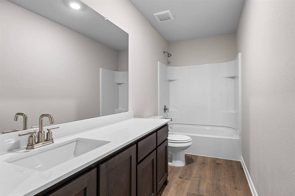 6307 Crosswood Lane, Dallas, TX 75241 Bathroom featuring shower / bath combination, vanity, and dark wood finished floors