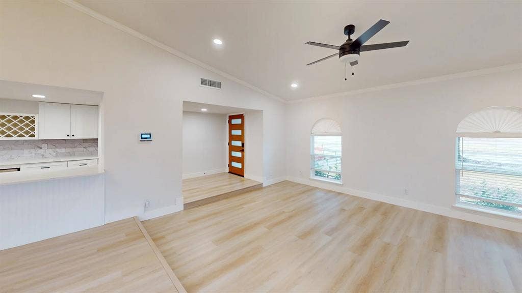 1506 W Spring Creek Parkway, Plano, TX 75023 Vaulted ceilings, wood-finish flooring, recessed lighting, arched windows, and a wood-panel front door with glass inserts
