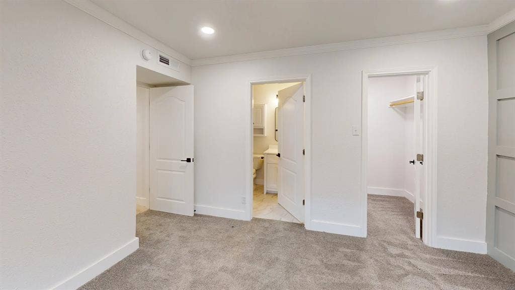 1506 W Spring Creek Parkway, Plano, TX 75023 Neutral carpeted flooring, recessed lighting, crown molding, paneled wall accent, and multiple interior doors with matte black hardware