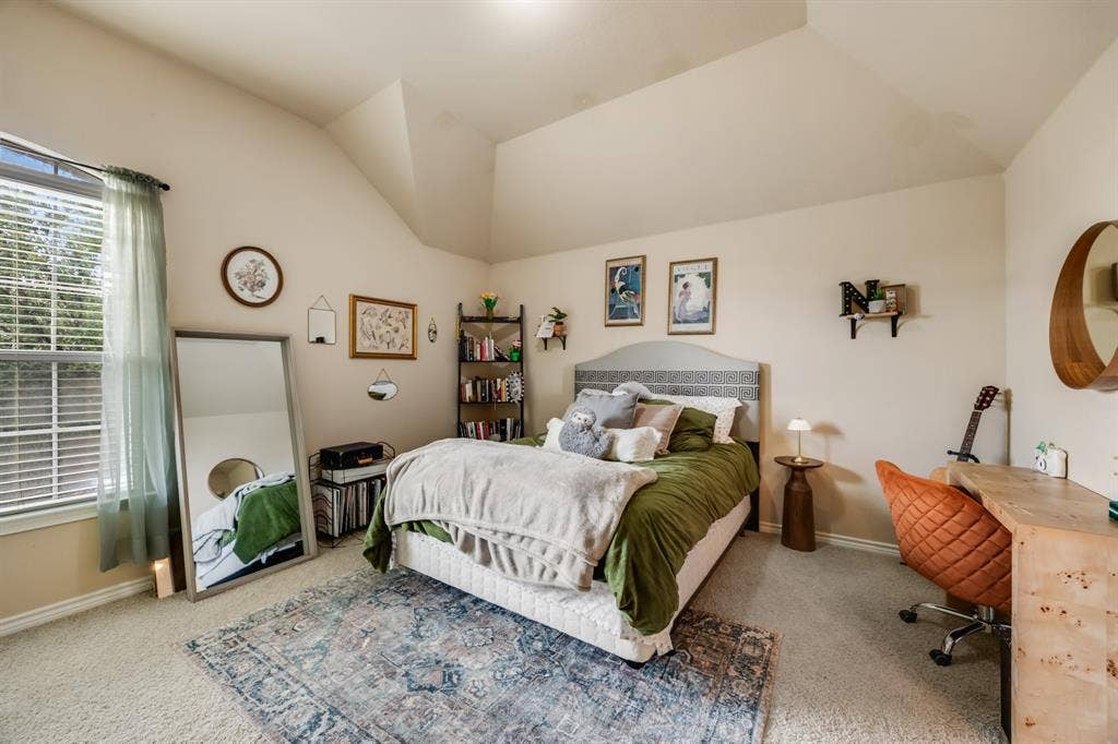 Bedroom with carpet and lofted ceiling