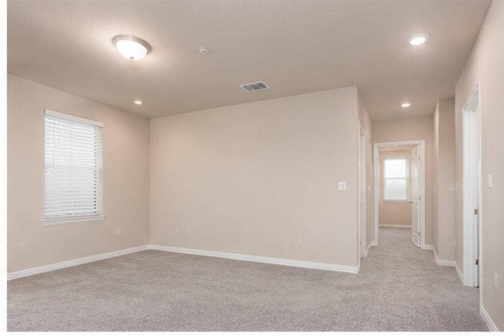 3704 Banton Street, Rowlett, TX 75089 Interior room featuring neutral wall tones, plush wall-to-wall carpeting, recessed lighting, and a window with horizontal blinds