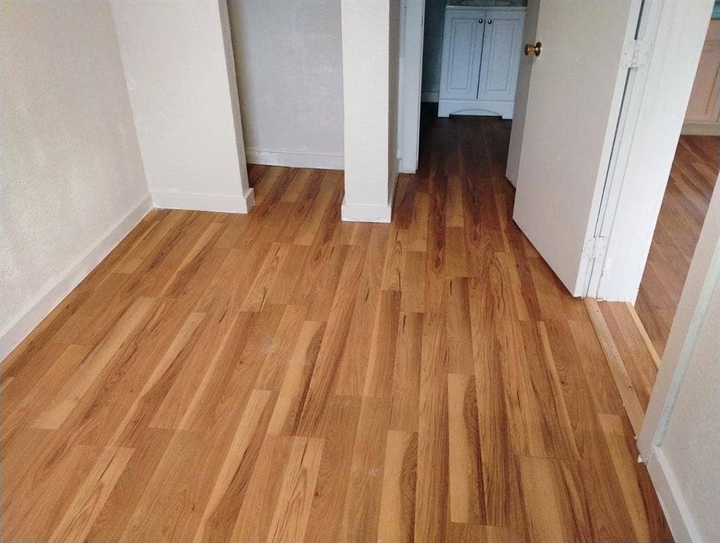 412 N Saint Augustine Drive, Dallas, TX 75217 Wood-finish flooring throughout, featuring neutral wall tones and white trim