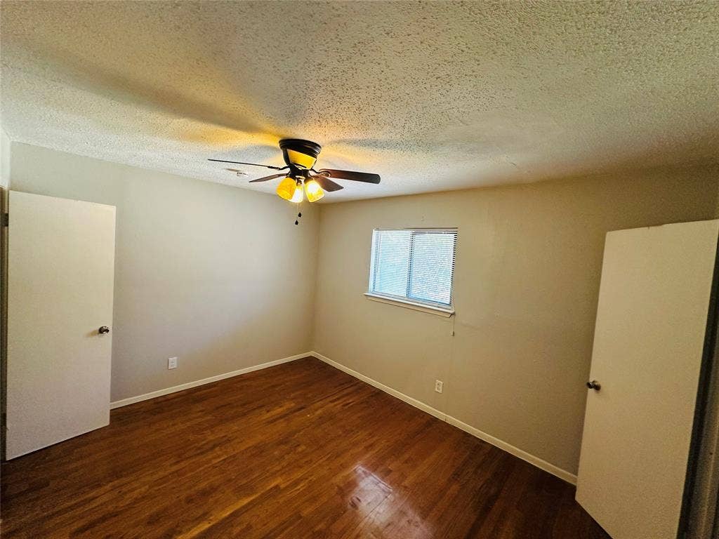 5317 Junius Street, #212, Dallas, TX 75214 Wood-finish flooring, ceiling fan with integrated lighting, and dual doors