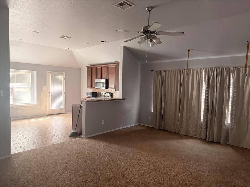 705 Bamboo Drive, Anna, TX 75409 Vaulted ceilings featuring a brushed nickel ceiling fan with integrated lighting, recessed lighting, tile flooring, and built-in cabinetry