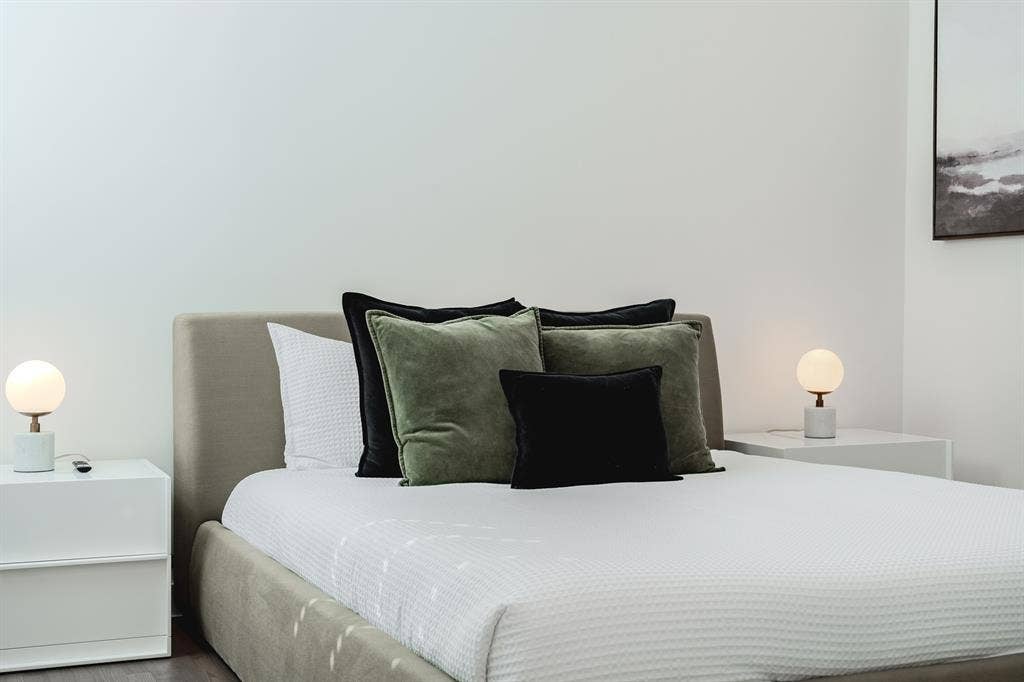 1502 Bennett Avenue, #106, Dallas, TX 75206 Neutral-toned upholstered headboard with a low-profile frame