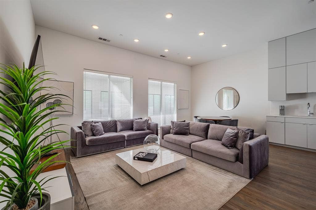 1502 Bennett Avenue, #106, Dallas, TX 75206 High ceilings, recessed lighting, wood-finish flooring, and built-in minimalist cabinetry with an integrated sink