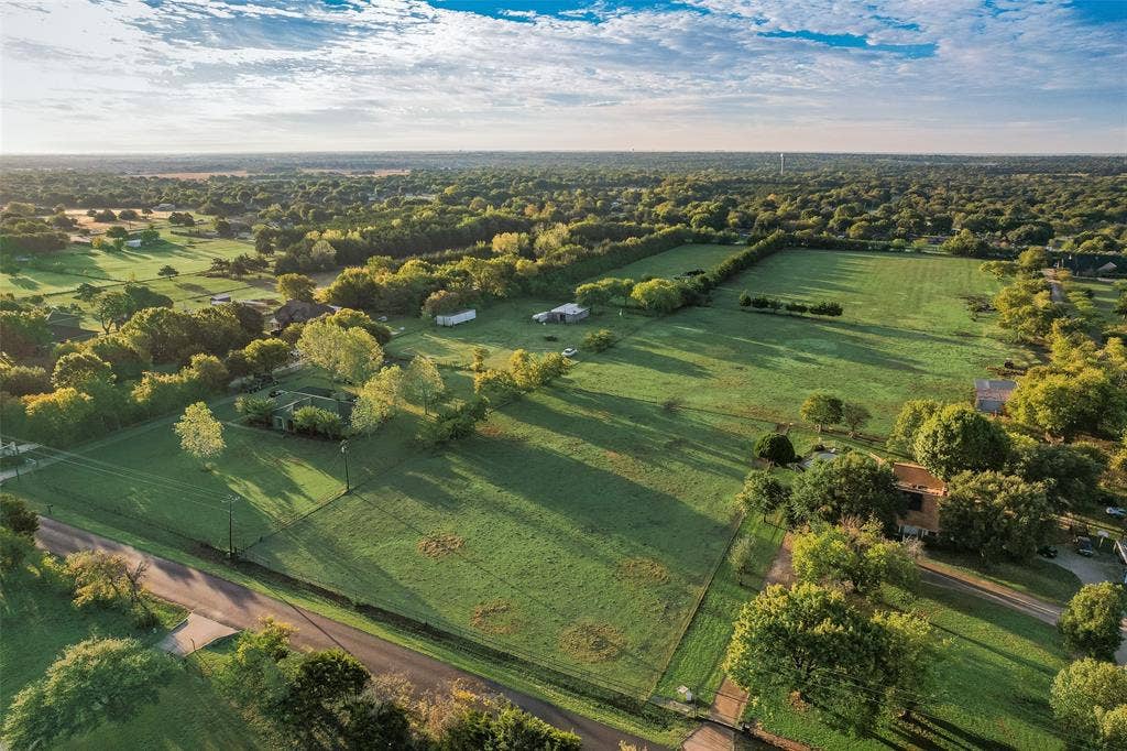 0 Johnson Lane, Ovilla, TX 75154 Aerial perspective of expansive acreage featuring mature hardwood trees, perimeter fencing, and open pasture land