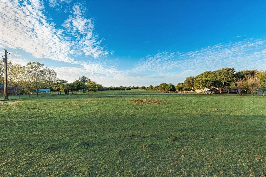 0 Johnson Lane, Ovilla, TX 75154 Expansive open acreage featuring level topography, mature perimeter trees, and wire perimeter fencing