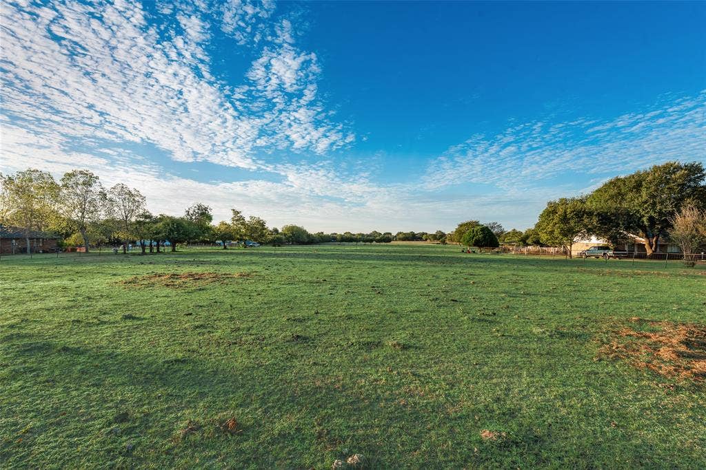 0 Johnson Lane, Ovilla, TX 75154 Expansive open acreage featuring cleared grass terrain and mature perimeter trees