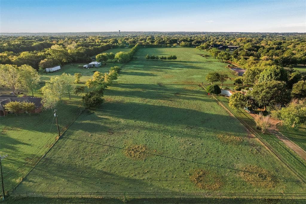 0 Johnson Lane, Ovilla, TX 75154 Expansive acreage featuring cleared pasture land, perimeter fencing, and mature tree clusters