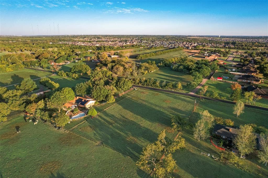 0 Johnson Lane, Ovilla, TX 75154 Aerial perspective of expansive acreage featuring mature trees, fenced pasture land, and an in-ground swimming pool