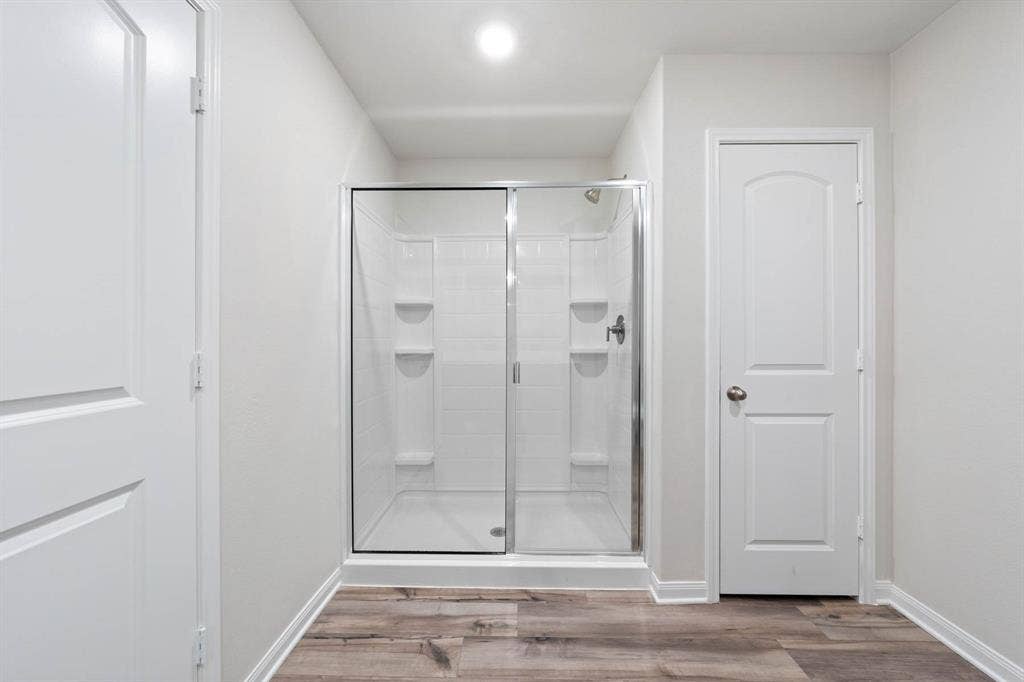 6308 Hyena Hollow Drive, Dallas, TX 75241 Bathroom featuring wood-type flooring and a shower with shower door