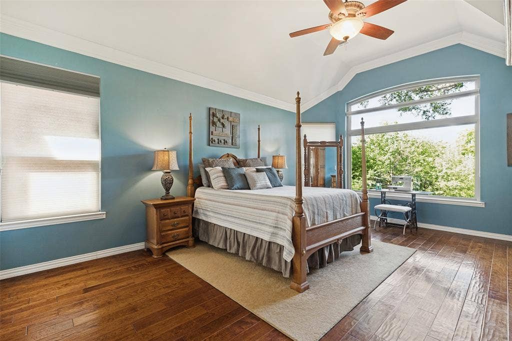 2404 Creek Ridge Drive, McKinney, TX 75072 Vaulted ceilings, wood-finish flooring, expansive windows, and a ceiling fan with integrated light fixture