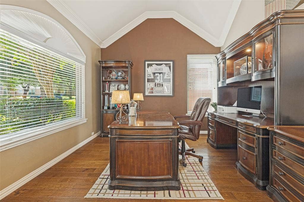 2404 Creek Ridge Drive, McKinney, TX 75072 Vaulted ceilings, wood-finish flooring, built-in cabinetry, and an arched picture window