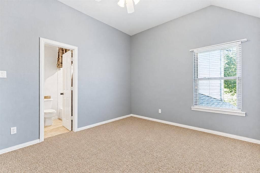 2404 Creek Ridge Drive, McKinney, TX 75072 Vaulted ceilings, neutral carpeting, light-toned wall paint, integrated ceiling fan, and horizontal window blinds