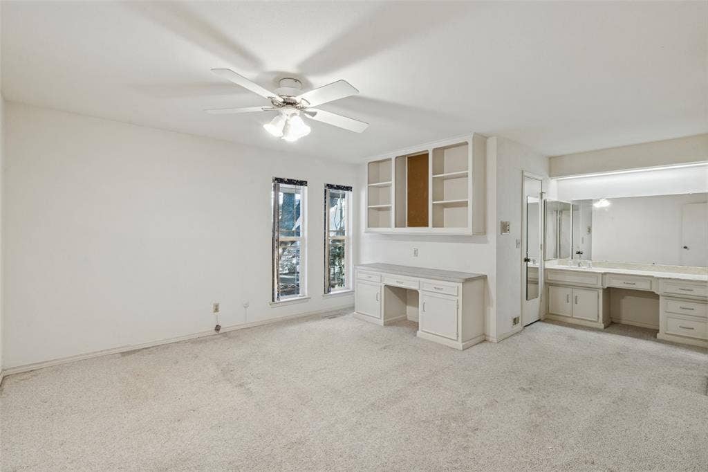 6936 Wildglen Drive, Dallas, TX 75230 Bedroom with desk area, separate vanity area, large walk-in closet and ceiling fan