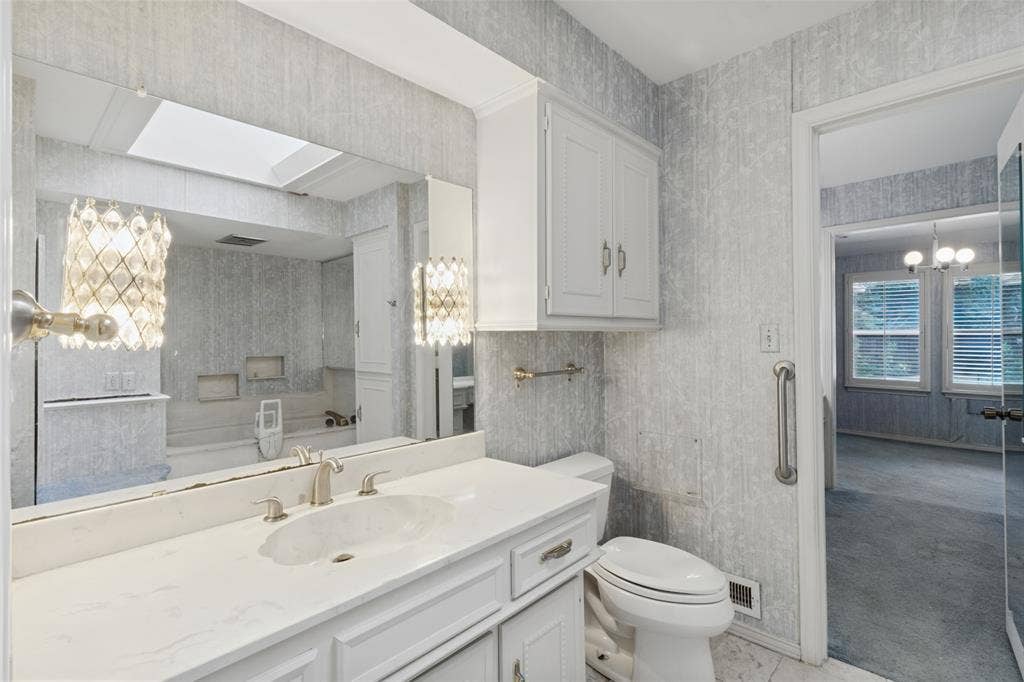 6936 Wildglen Drive, Dallas, TX 75230 Hall bath which is one of the baths that the primary bedroom can use with tub