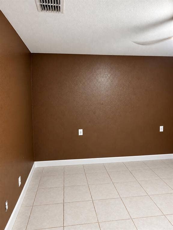 Neutral-toned ceramic tile flooring paired with solid-colored wall finishes