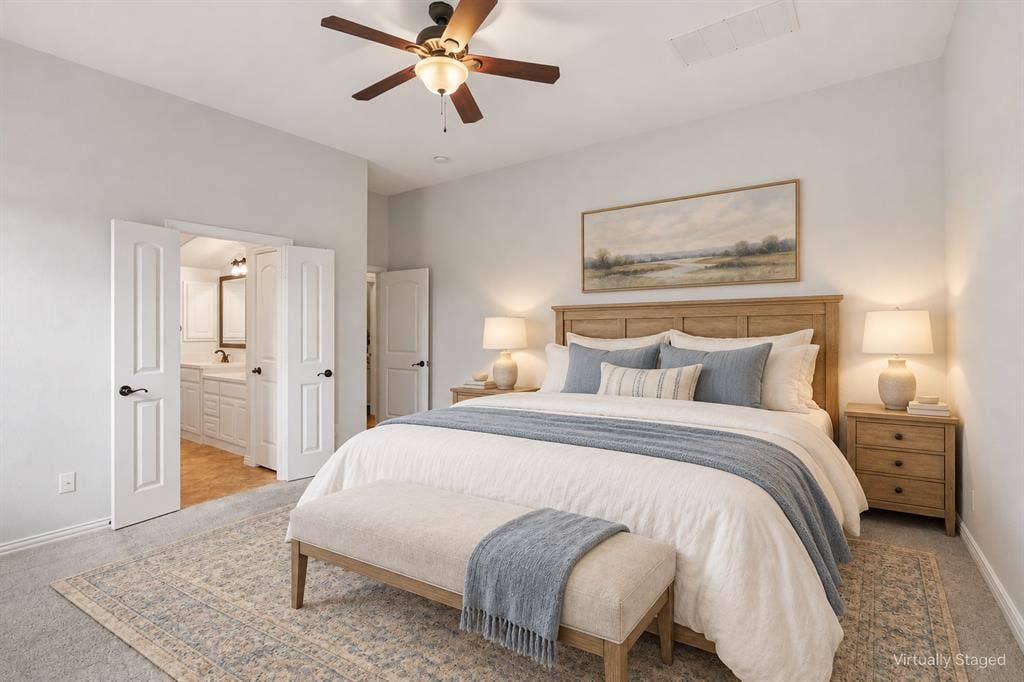 Spacious room featuring neutral carpeting, a central ceiling fan with integrated lighting, and multi-panel interior doors