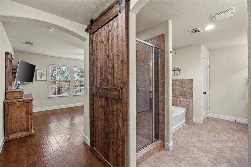 Wooden barn door is only one of this home's many amenities!